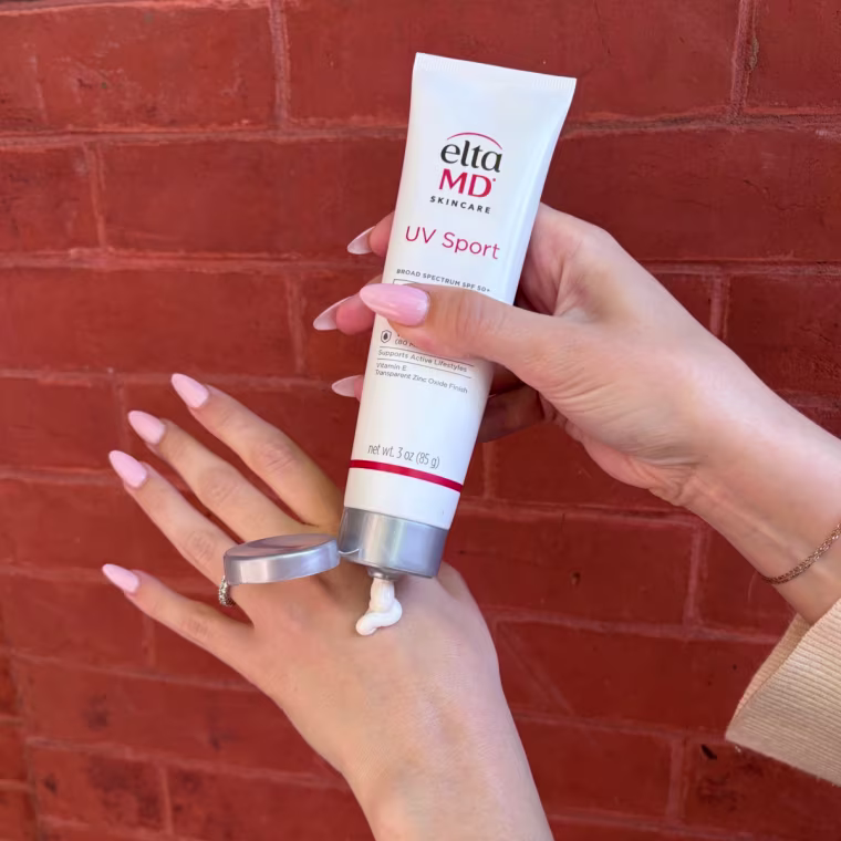 Woman applying sunscreen to back of hand