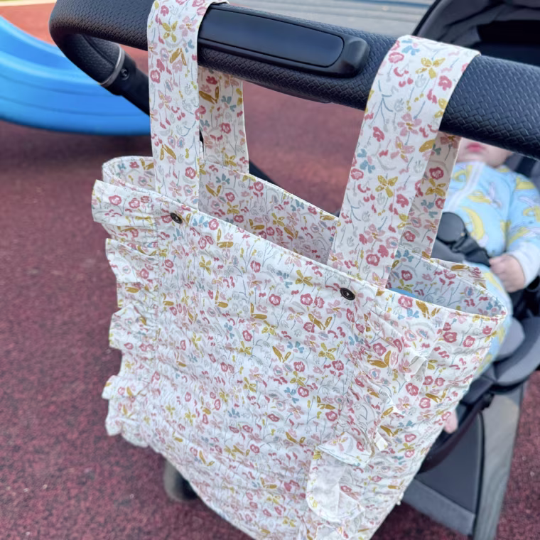 This stylish diaper bag stays secured to the handles of all kinds of strollers.