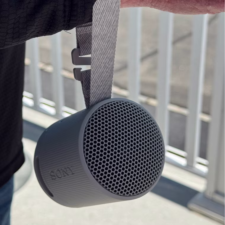 The Sony speaker has a convenient carrying strap that I can hold on my wrist.