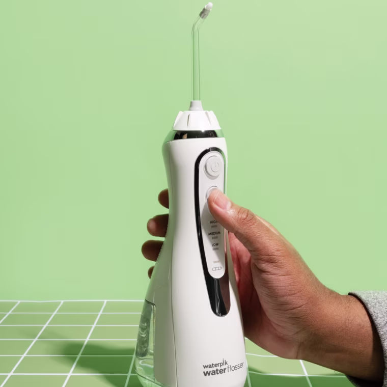 Waterpik Cordless advanced 2.0 water flosser on a green background