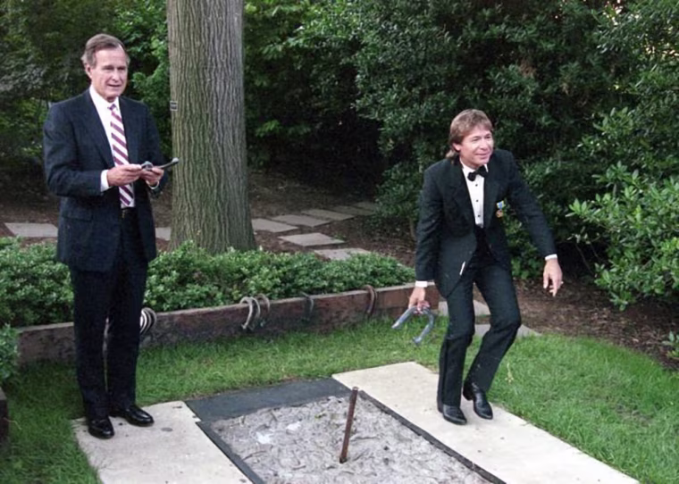 President Bush and John Denver pitch horseshoes in 1989.
