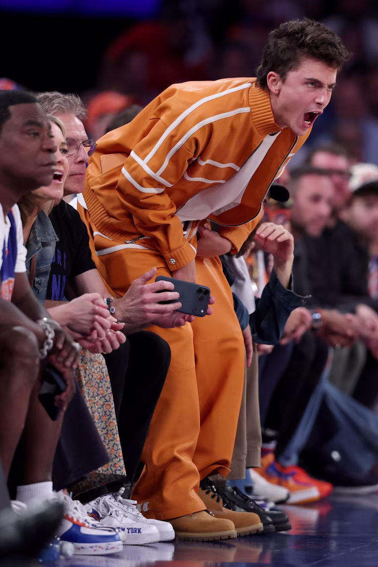 Timothee Chalamet cheers courtside.
