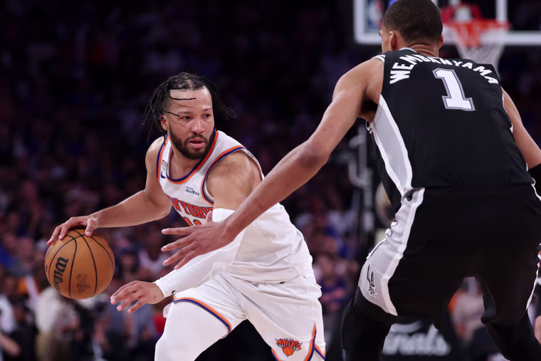Jalen Brunson #11 of the New York Knicks dribbles against Victor Wembanyama of the San Antonio Spurs during the third quarter in game four of the NBA Finals at Madison Square Garden on June 10, 2026.