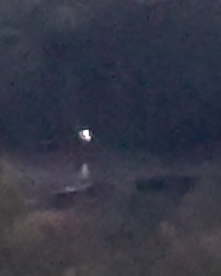 In October 2024, at approximately 1851 local time in the northeastern United States, an eyewitness observed a light source below the horizon, hovering above a pond at an estimated distance of 2,700 feet.