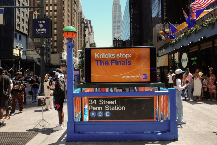 Madison Square Garden Subway Station is decorated in the orange and blue colors of the New York Knicks.