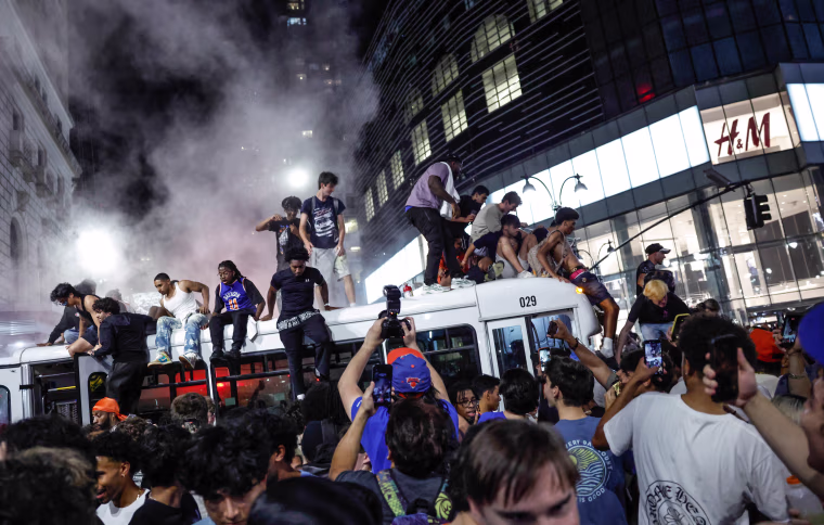 Knicks fans atop a bus in New York last night.