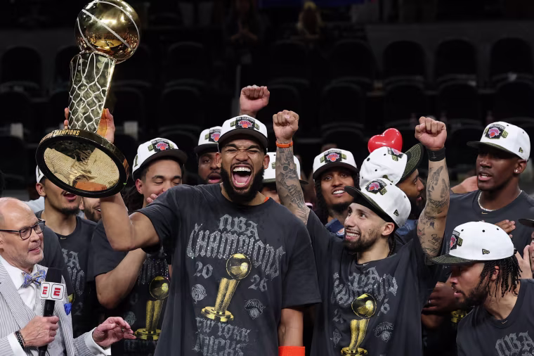 Karl-Anthony Towns of the New York Knicks lifts the Larry O'Brien Championship Trophy