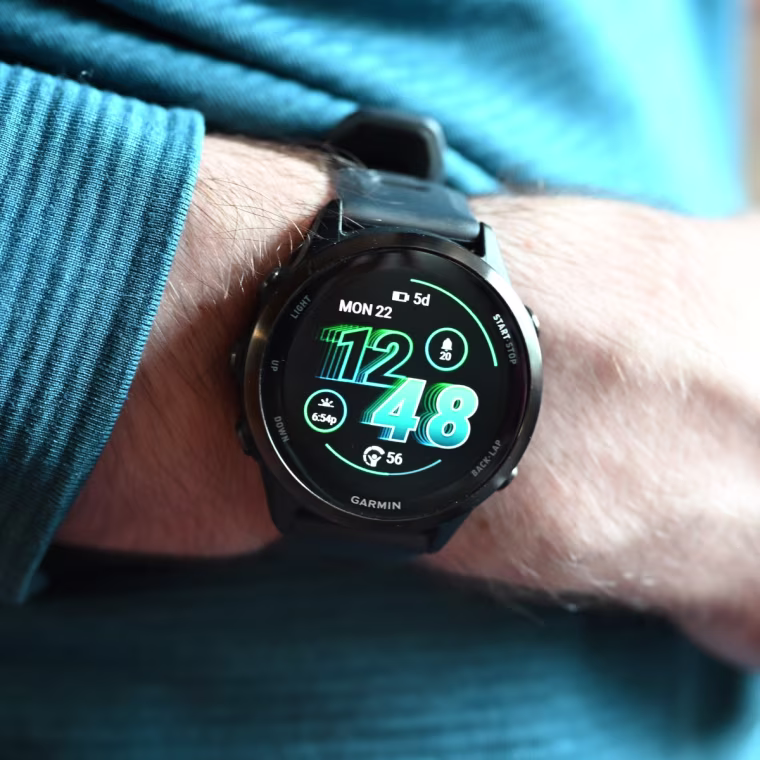 A close-up of the Garmin Forerunner 570 on the wrist of the writer.
