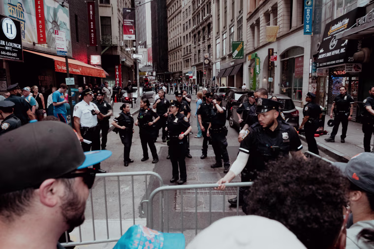 Police adjust barricades at a security checkpoint at Nassau Street and Maiden Lane.