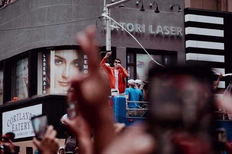 Actor Timothée Chalamet on a float with Knicks alumni, including Carmelo Anthony, during the championship parade.