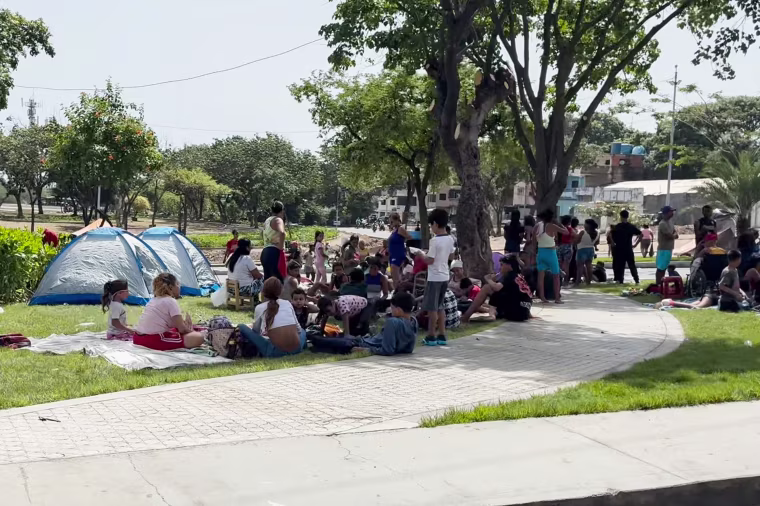 People camp in an open space in La Guaira, Venezuela.