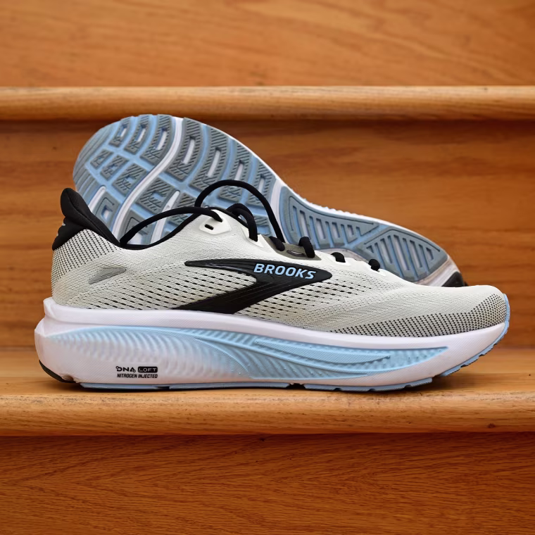 A close-up of the Brooks Ghost 18 resting against a wooden stair.