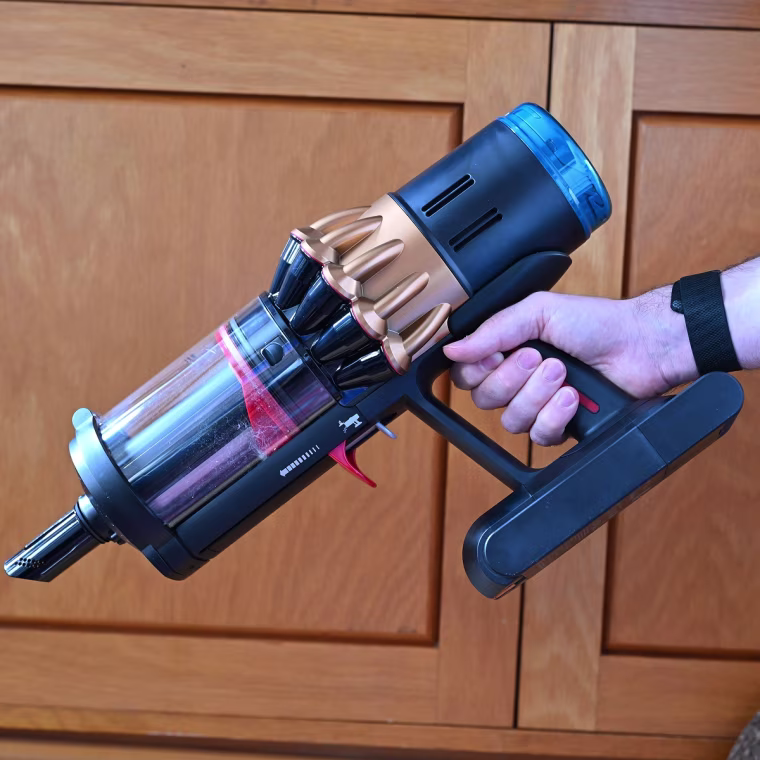 A close up of the Dyson V16 Piston against a wood cabinet in the background.