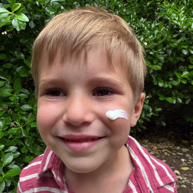 Child with sunscreen on face
