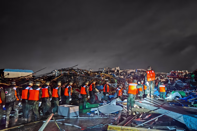 Armed police officers carry out rescue operations.