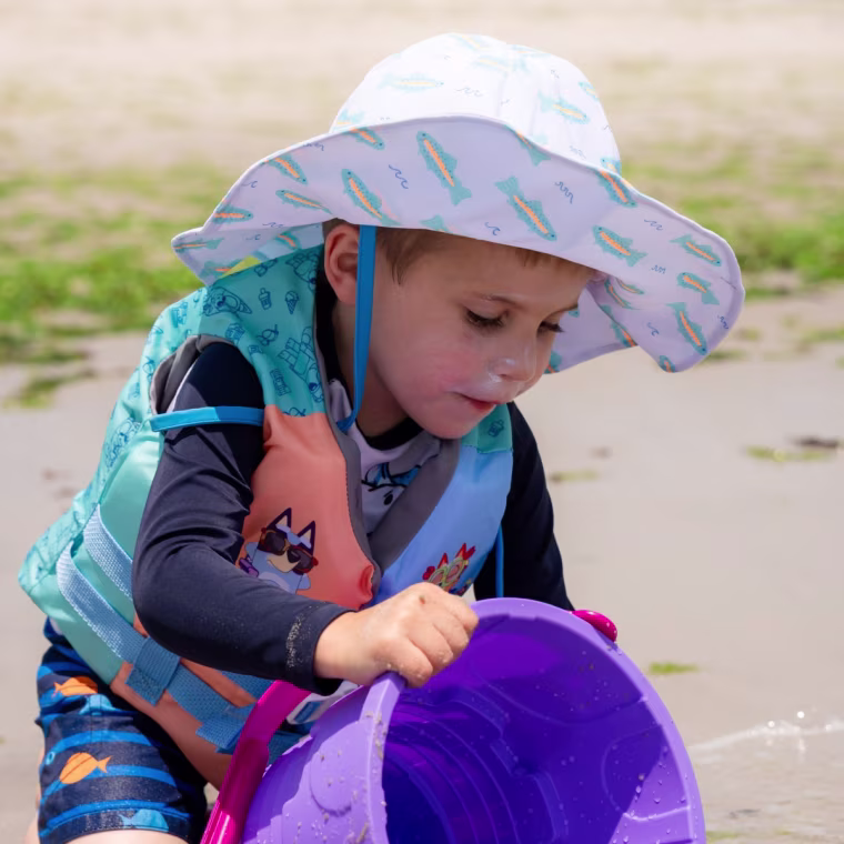 Caden Lane's sun hat kept his face out of the sun all day and didn't budge even mid sandcastle-building.