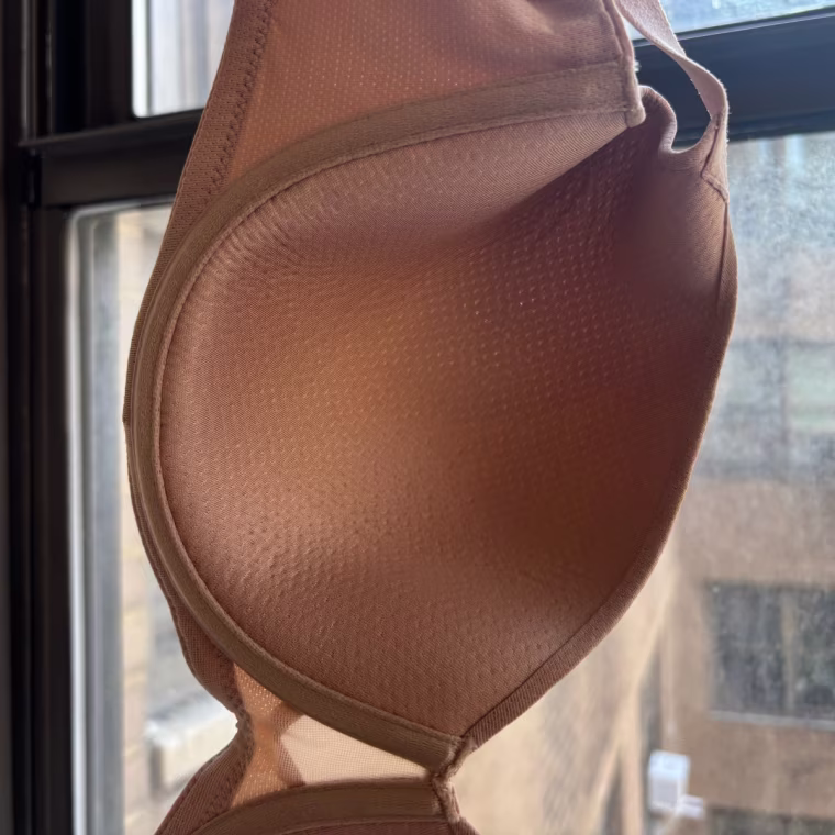 A close-up image of the inside of a cup on the Thirdlove TempSync T-Shirt Bra, showing the tiny perforations in the nude-colored material.
