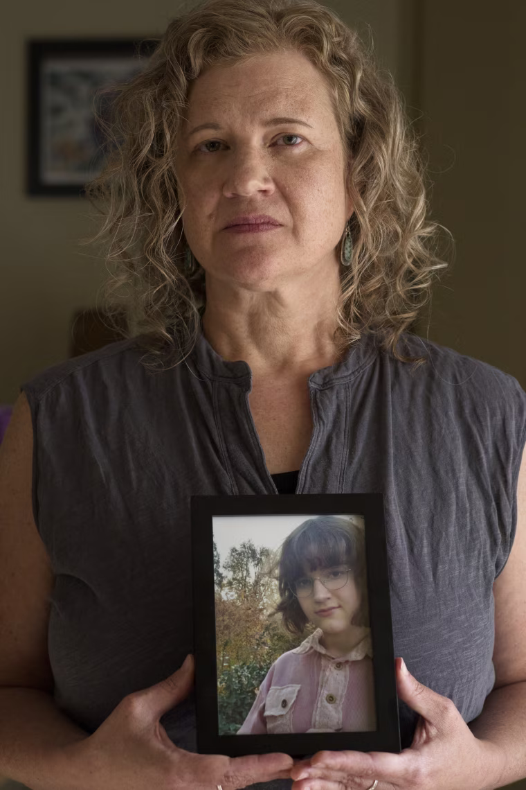 Elyse Thorpe holds a framed photo of May.