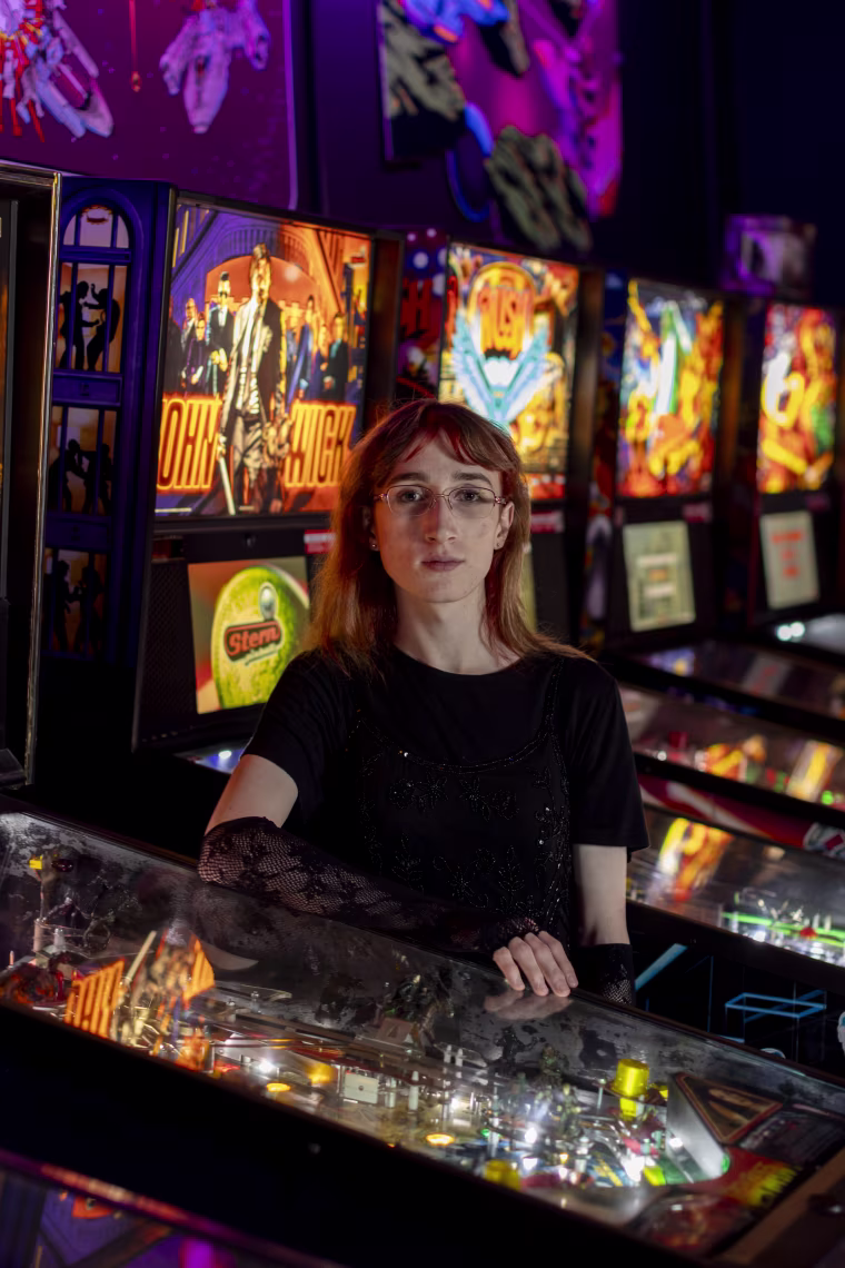 Emi Erwin near pinball machines.