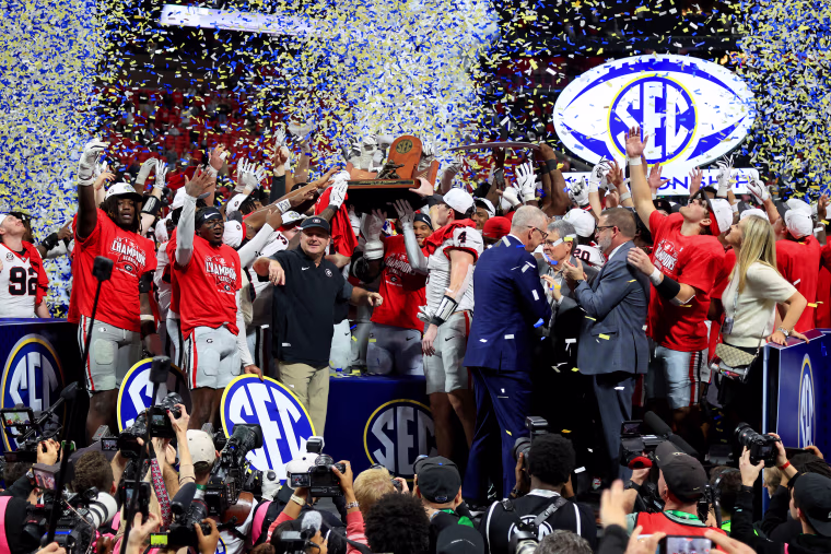 Head coach Kirby Smart of the Georgia Bulldogs and the team celebrates the victory in the SEC Championship college football game.