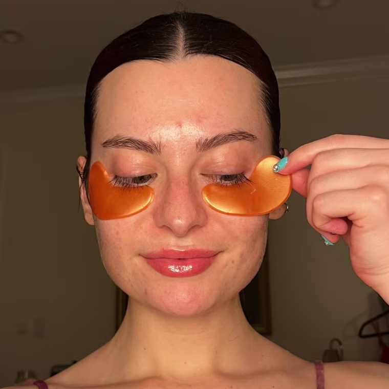 Associate market editor Audrey Ekman applies the Grace & Stella Brightening Vitamin C Eye Masks.