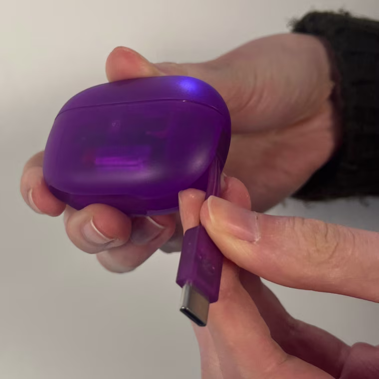 These JLab earbuds have the charging wire built in to the case.