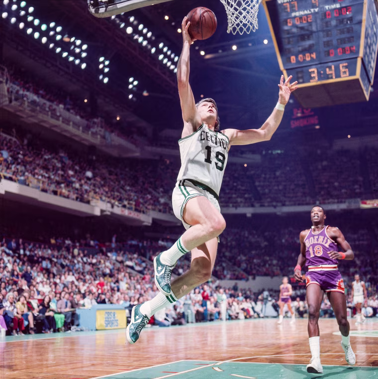 Don Nelson jumps up to make a basket on the court