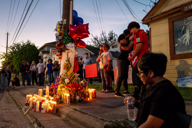People stand and protest at a vigil in Houston, Texas.