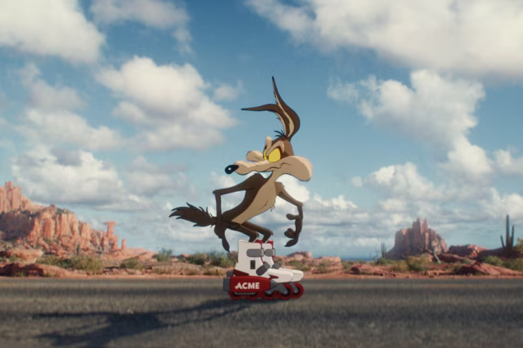 An animated coyote standing on the middle of the street while wearing rolling skates.