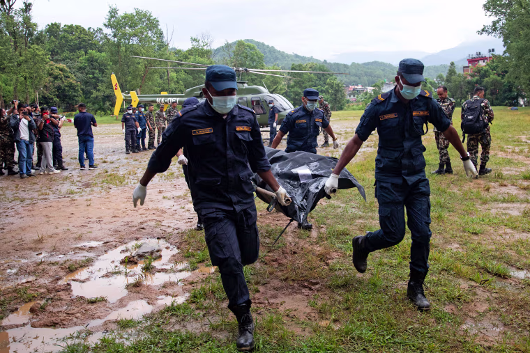 Nepali Army personnel carry bodies of deceased victims during rescue operations in Nepal's Nuwakot district on August 28, 2026. 