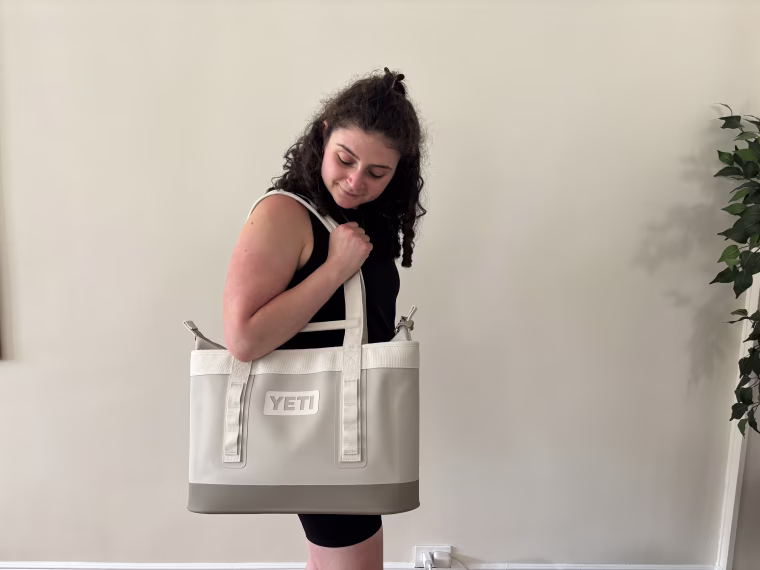 Woman holding a white Yeti Camino.
