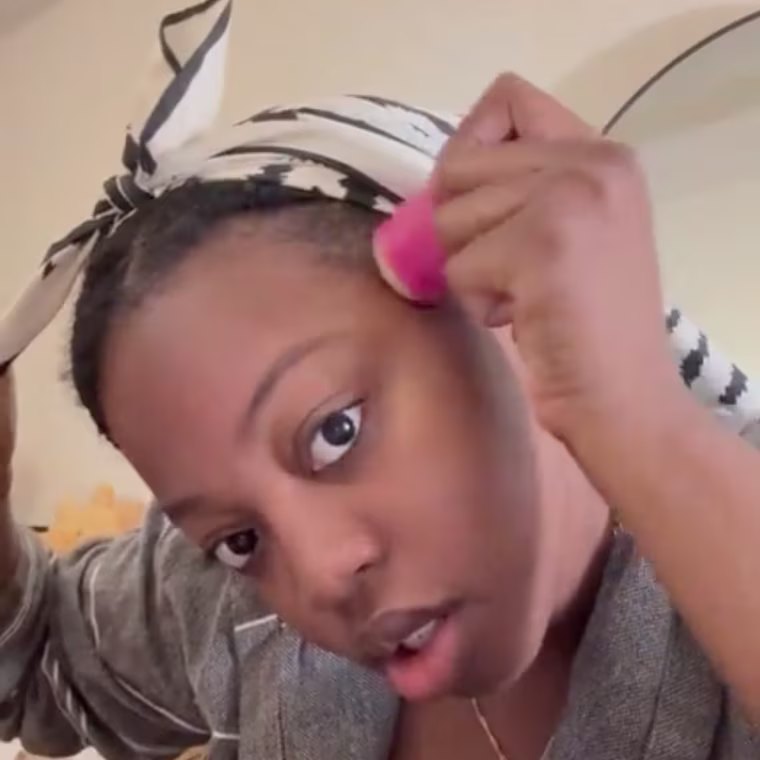Gif of woman applying wax stick to edges of hair