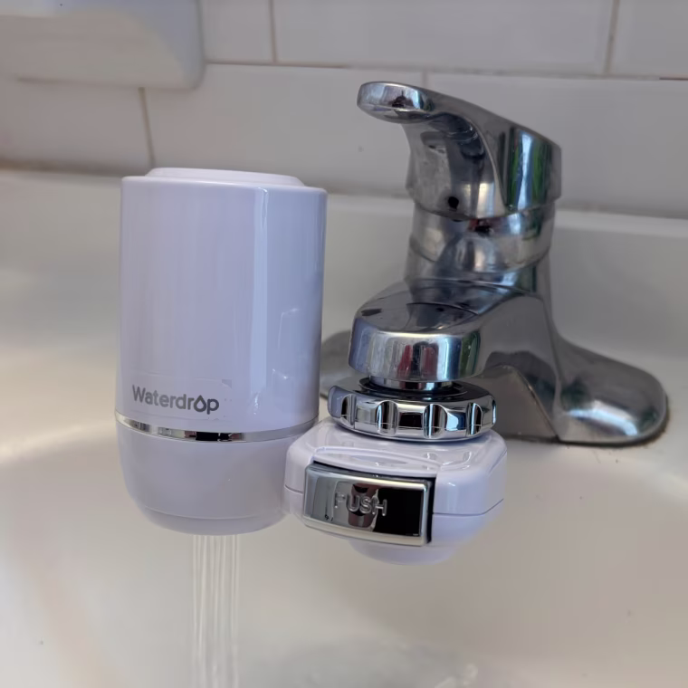 A white Waterdrop Sink installed on a bathroom sink.