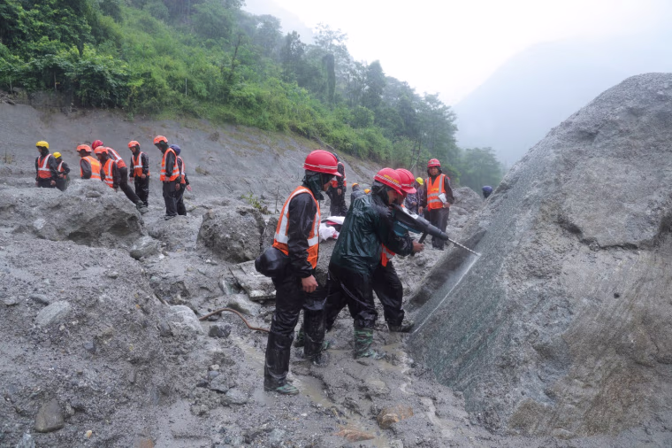Image: Nepal army soldiers use a drilling machine during a rescue operation at the site of a hydropower project in Upper Trishuli, Nepal.