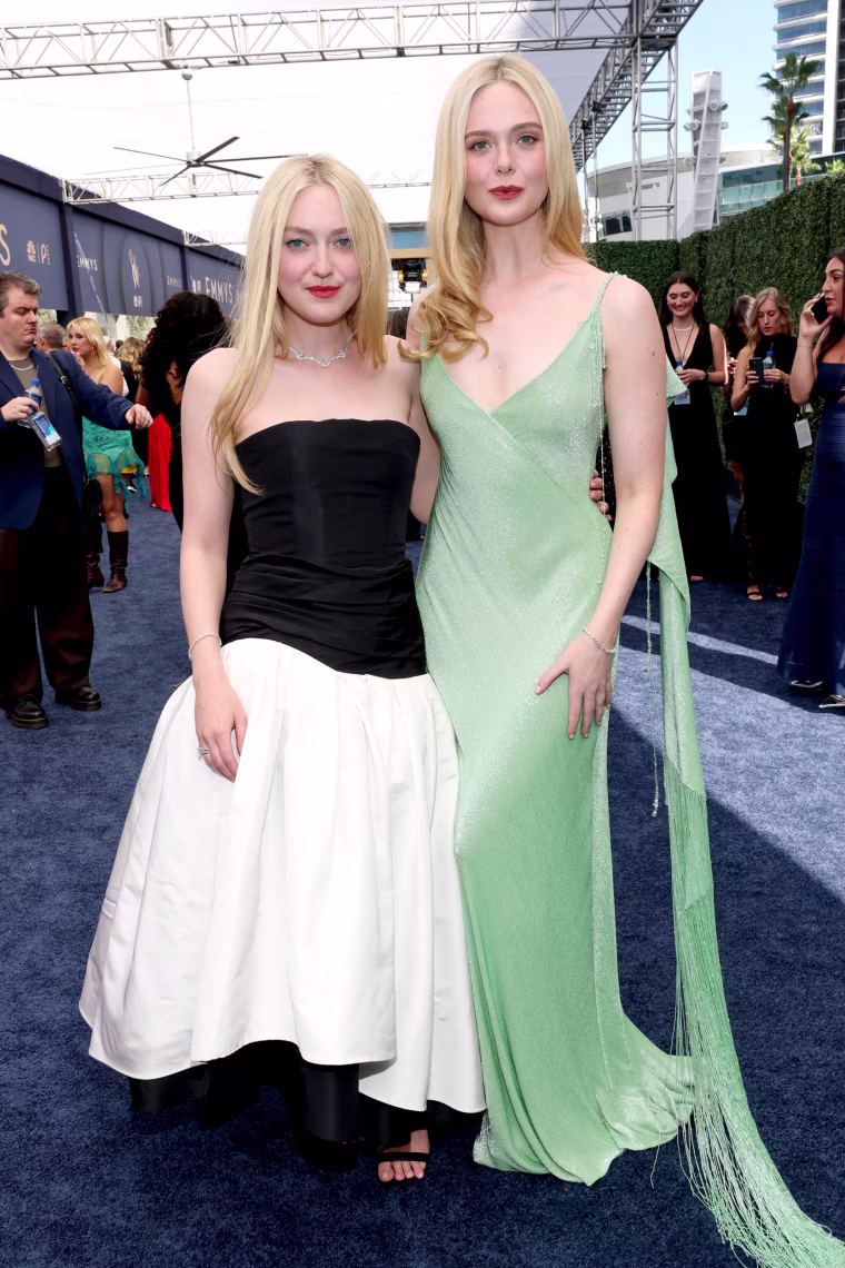 Dakota and Elle Fanning pose together.