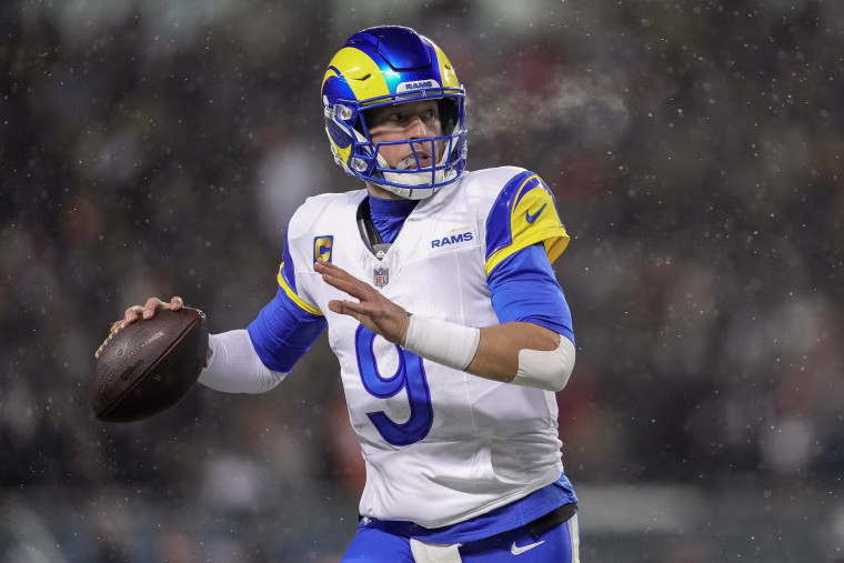 Matthew Stafford winds up to throw the football during gameplay in the snow. 