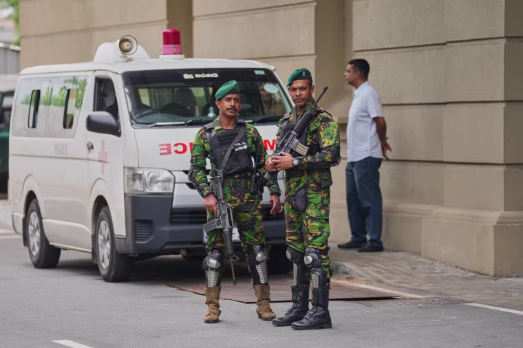 Police commandos stand.