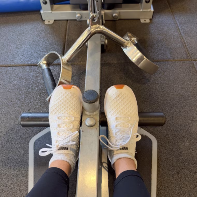 Person wearing the NoBull Women’s Allday Knit Sneakers on a machine.