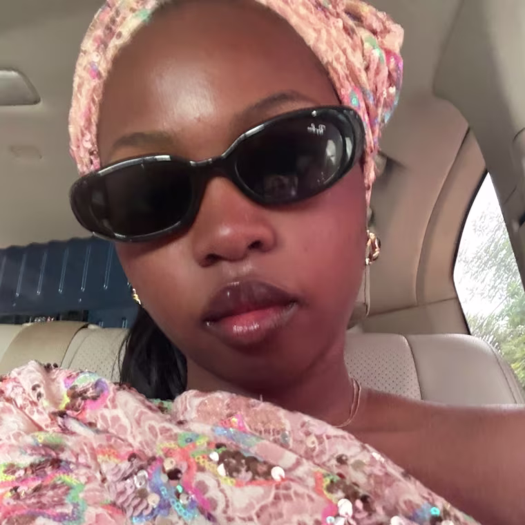 A woman wearing black Ray-Ban sunglasses.