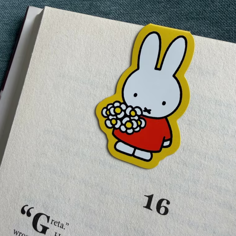 Miffy magnetic bookmark in yellow on a book page.