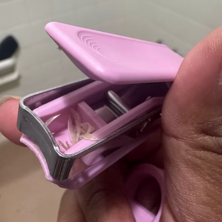 A close-up shot of the EDJY nail clipper holding nail clippings.