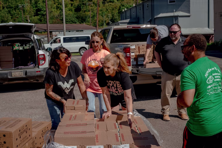 Organizers of several food pantries pick up boxes of food delivered by Facing Hunger Foodbank in Williamson, W.Va.