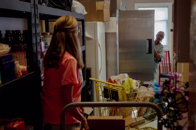 Donna Paterino, left, gathers food for Mary Blackwell, right, at the Widow's Mite Food Pantry on Sept. 15.