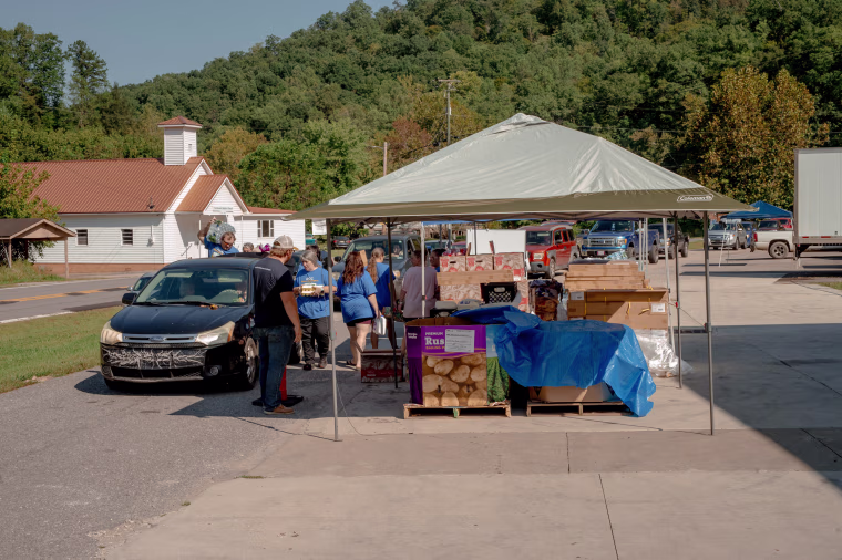 A mix of staff and volunteers distribute donated food