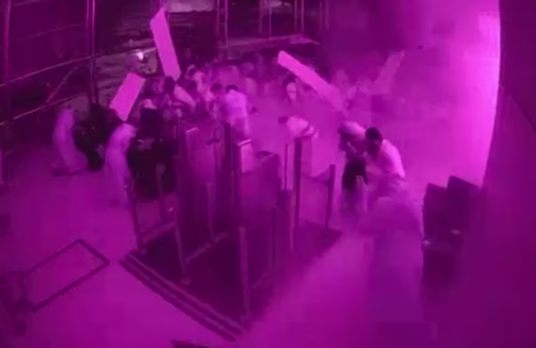This image from CCTV video released by Saudi Arabia's Media Ministry shows passengers taking cover as flames and smoke fill part of King Khalid International Airport in Riyadh, Saudi Arabia, during what authorities described as a strike at the airport on Saturday, Oct. 10, 2026. (Saudi Media Ministry via AP)