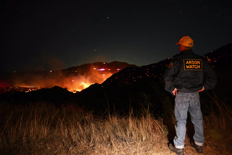An Arson Watch volunteer overlooking the Bryson Fire burning in Malibu, California on October 15, 2026.