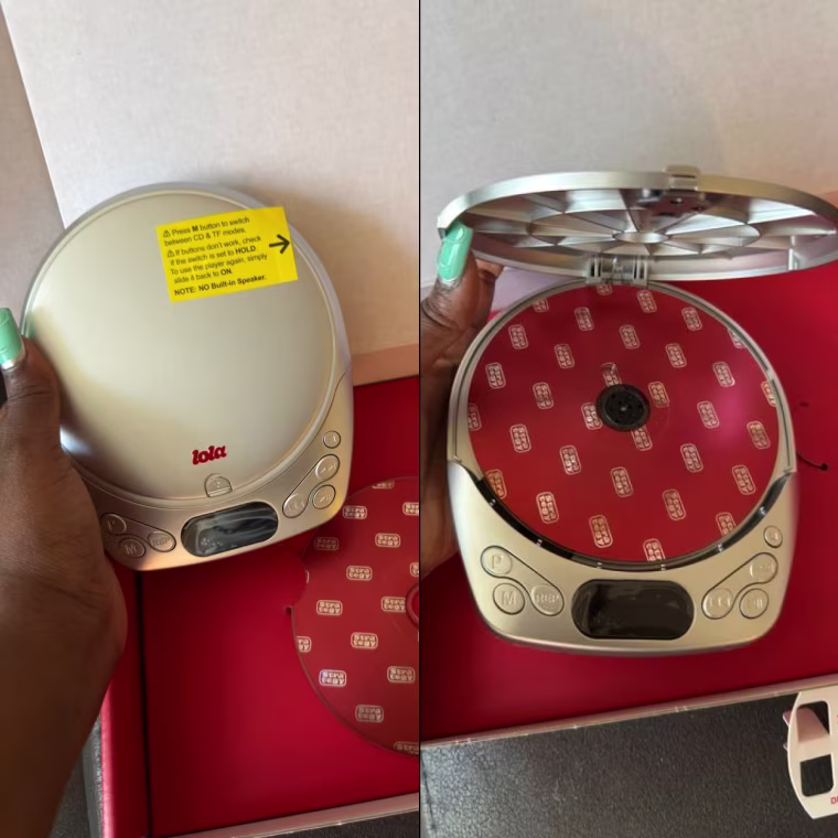 The Lola CD player being held closed and open in front of the box.