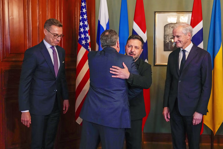 Image: President Volodymyr Zelensky hugs Steve Witkoff, as Norway's Prime Minister Jonas Gahr Store and Finnish President Alexander Stubb look on.