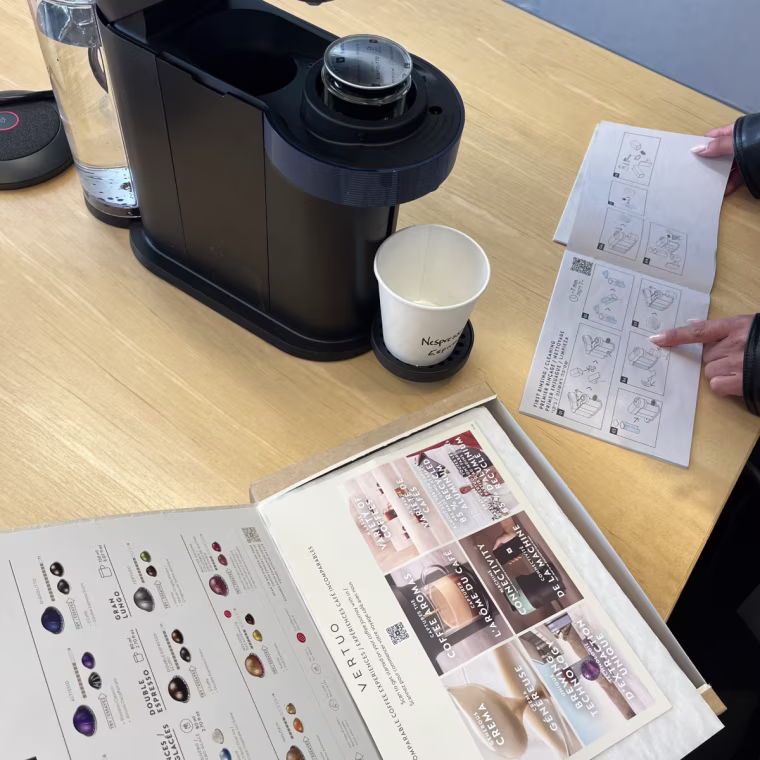 Reading through the instructions to set up the Nespresso before brewing a pod for the first time. The machine also came with a sampler box of different pods to try.