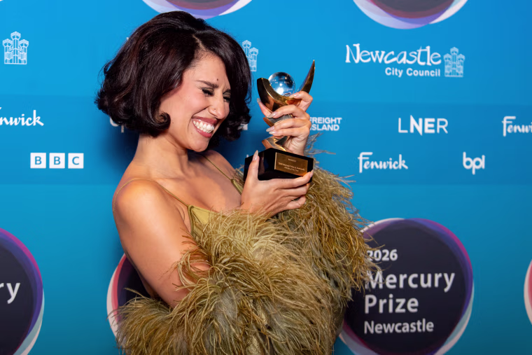 Image: Raye holding the Mercury prize.